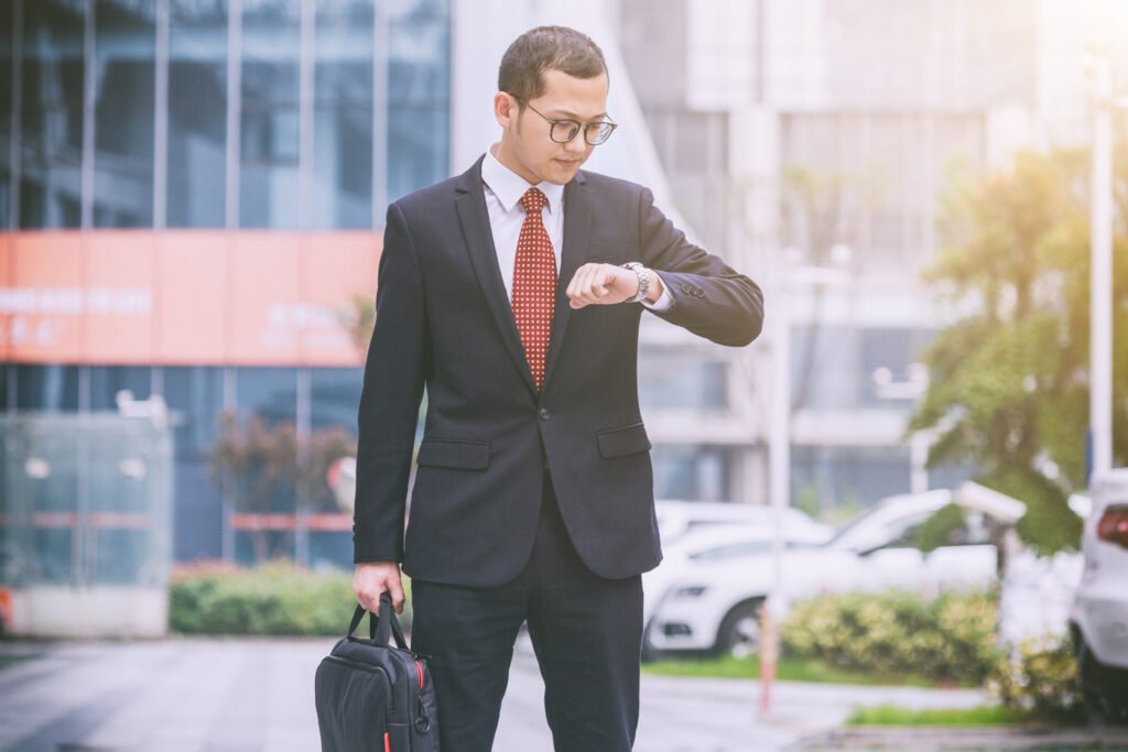 business men carry laptops parking lot