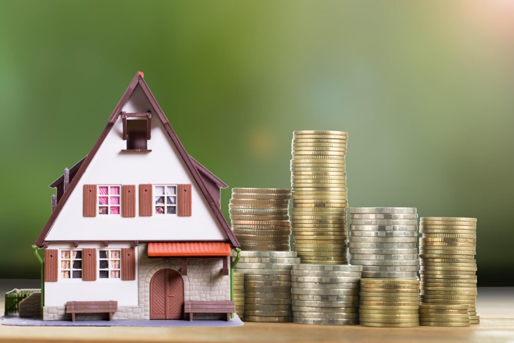 miniature house stack coins real estate investment concept