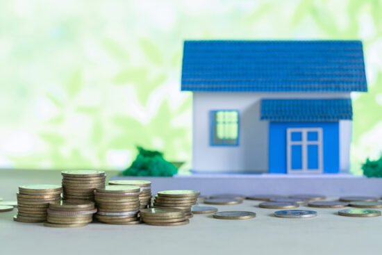 model house with coins wooden table
