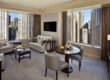 comfortable round table surrounded by sleek chairs bright minimalist apartment showcasing large window with curtains mounted tv wall
