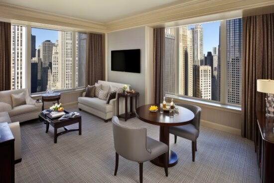 comfortable round table surrounded by sleek chairs bright minimalist apartment showcasing large window with curtains mounted tv wall